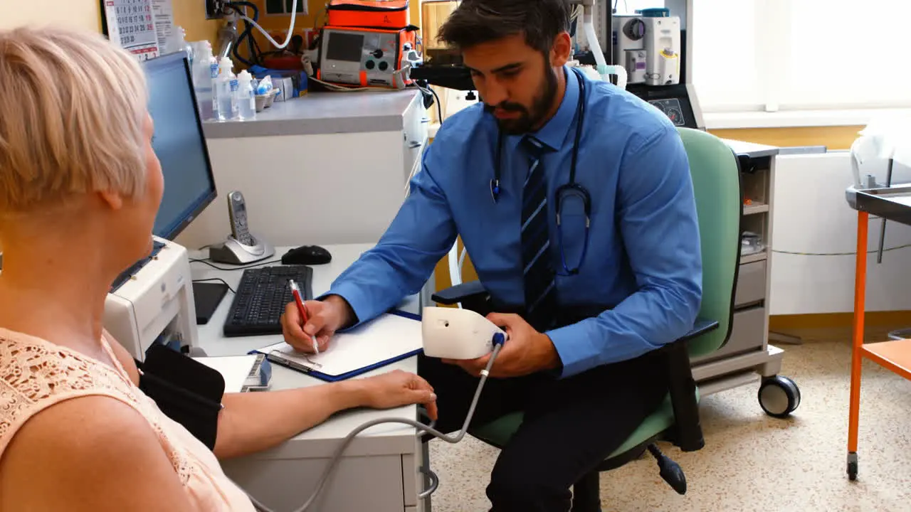 Doctor checking blood pressure of patient