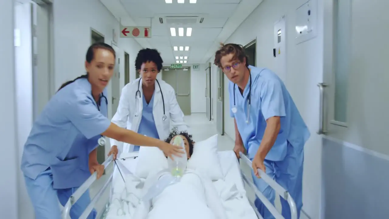  medical team pushing emergency stretcher bed in the corridor at hospital