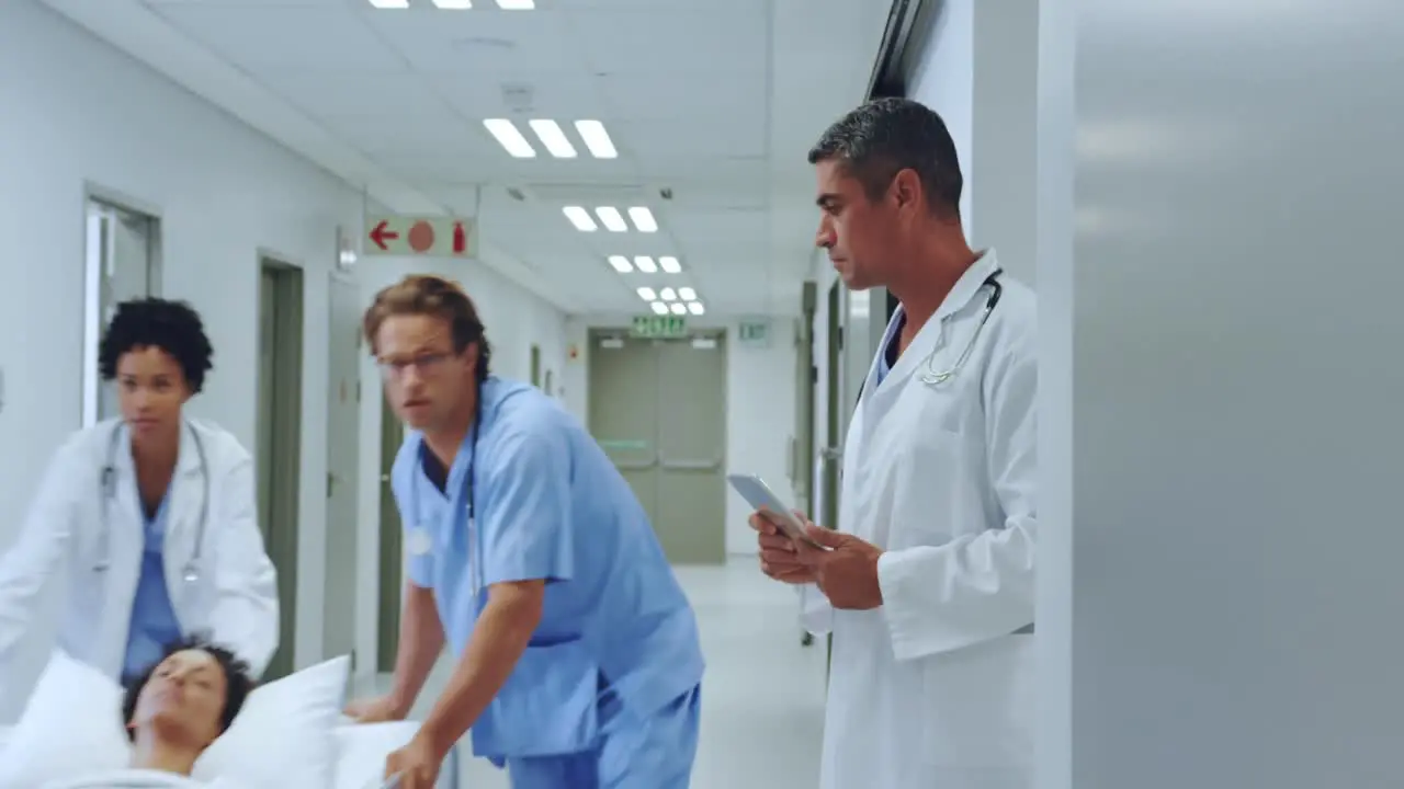 Medical team pushing emergency stretcher bed in the corridor at hospital