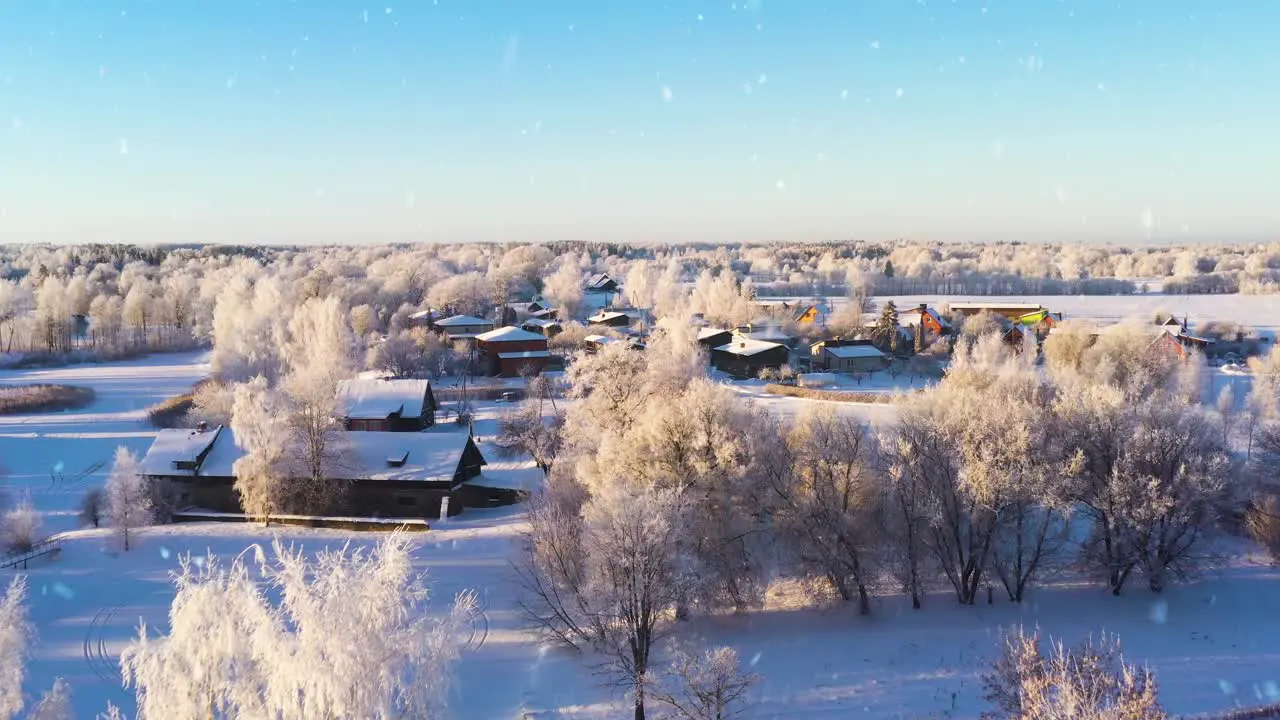 Residential buildings covered in snow on sunny winter day aerial view