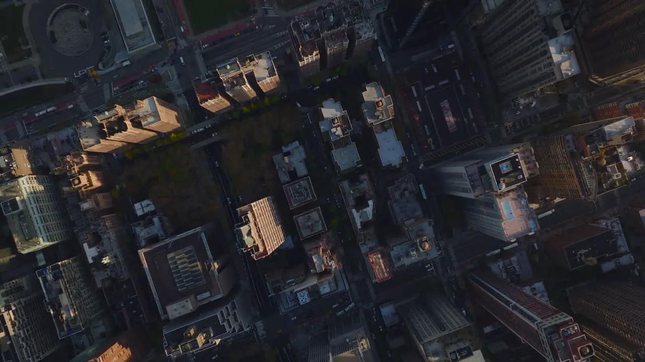 Aerial birds eye overhead top down panning view of city development Blocks of buildings surrounded by streets in autumn city Manhattan New York City USA