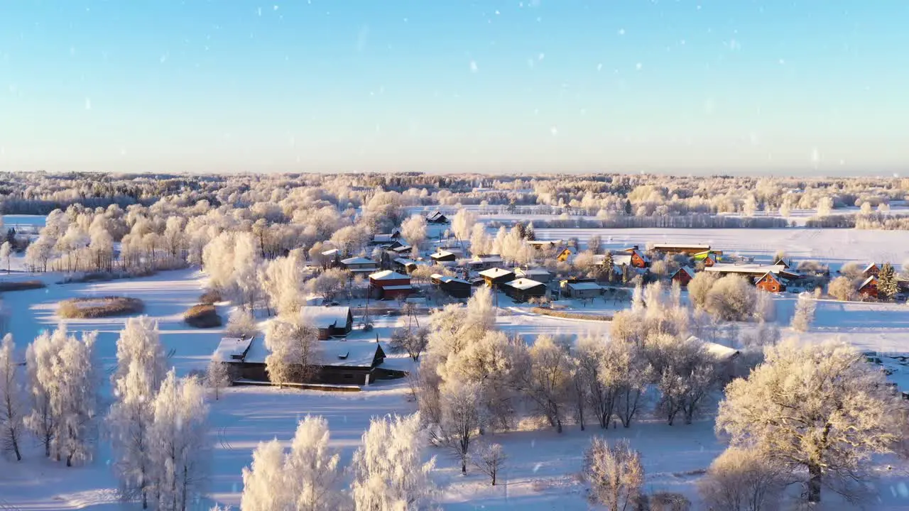 Magical winter township and natural surroundings during snowfall aerial view