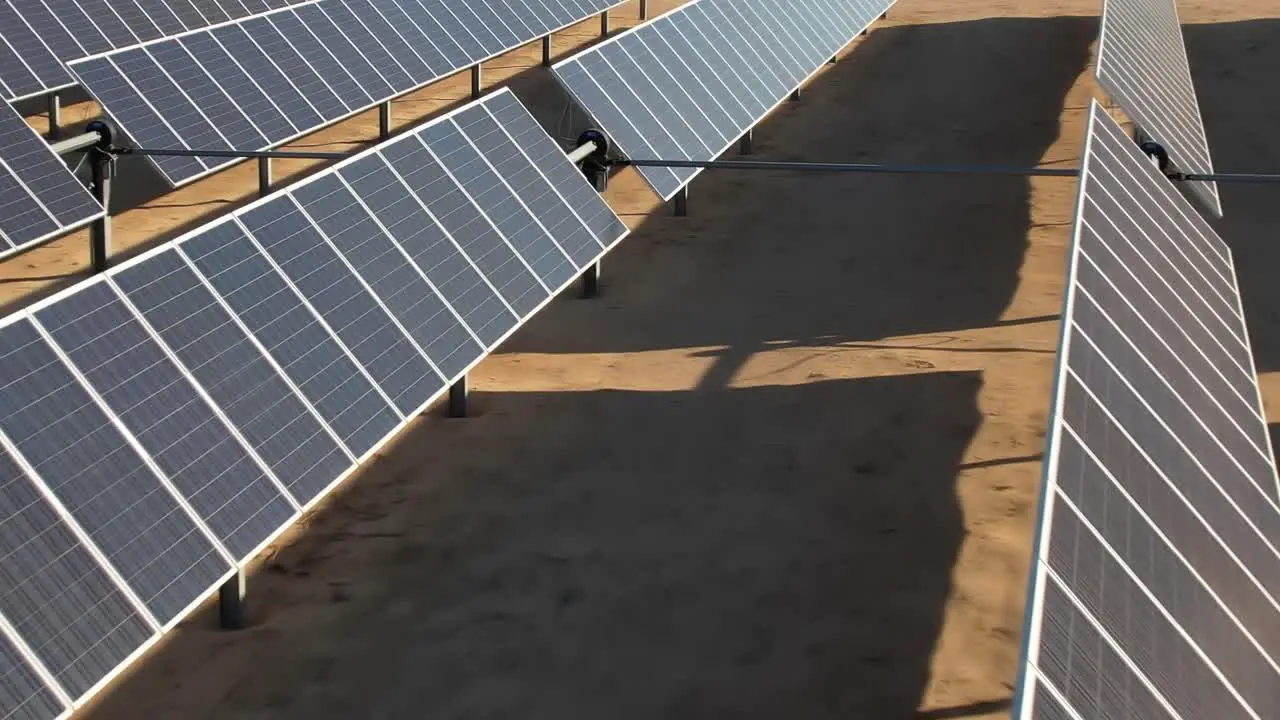 Aerial over up close solar panels photovoltaic farm of energy powered by the sun