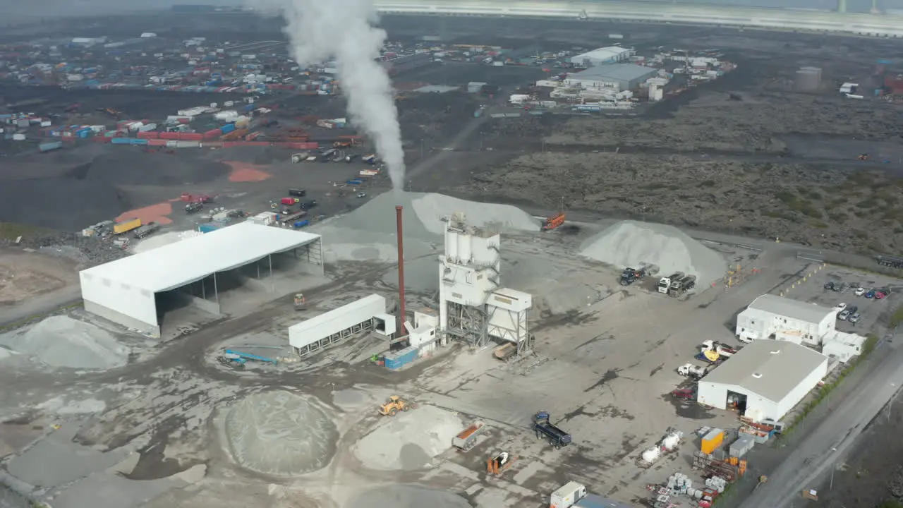 Aerial view slowly rotating around an asphalt industry in Iceland Drone view rotation showing hundreds of containers ready to be export