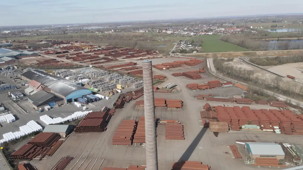 Jib up of old smoke stack overlooking large industrial junk yard