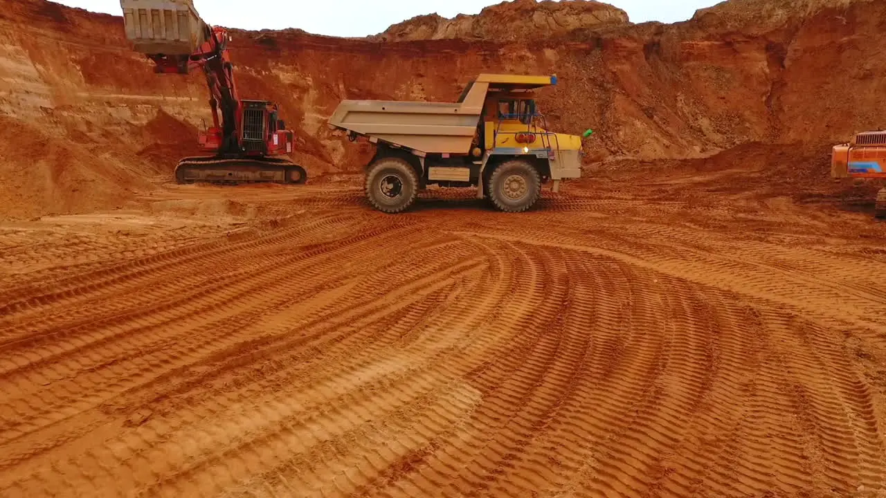 Mining truck moving at sand mine Mining machinery working at sand quarry