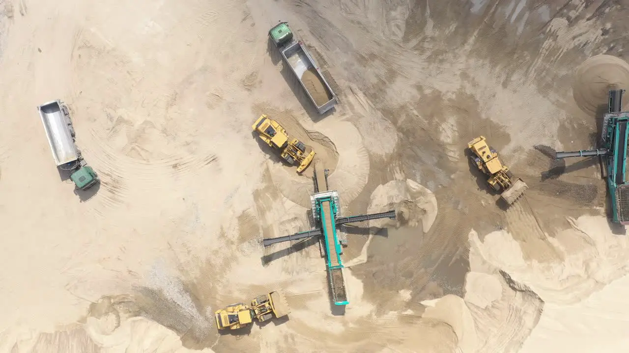 Aerial view loading bulldozer in open air quarry