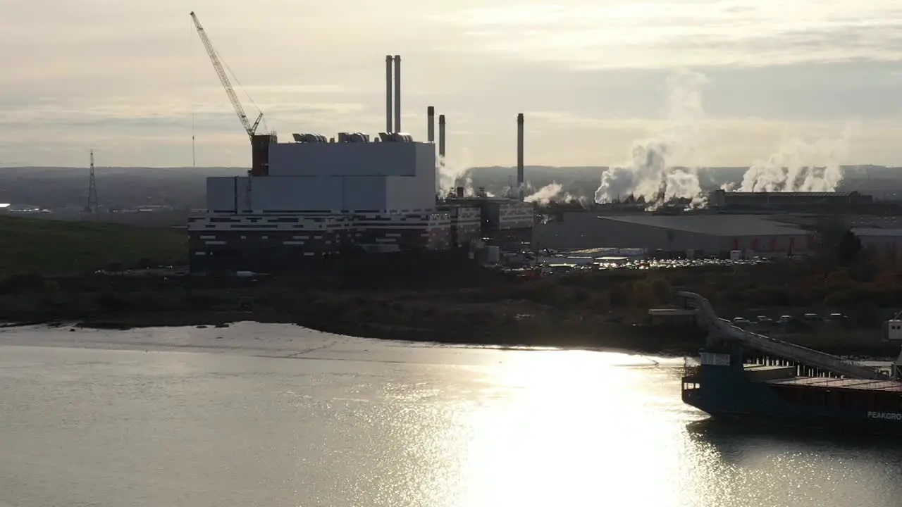 Aerial profile slider shot of industry located on the Swale Estuary in Kemsley UK