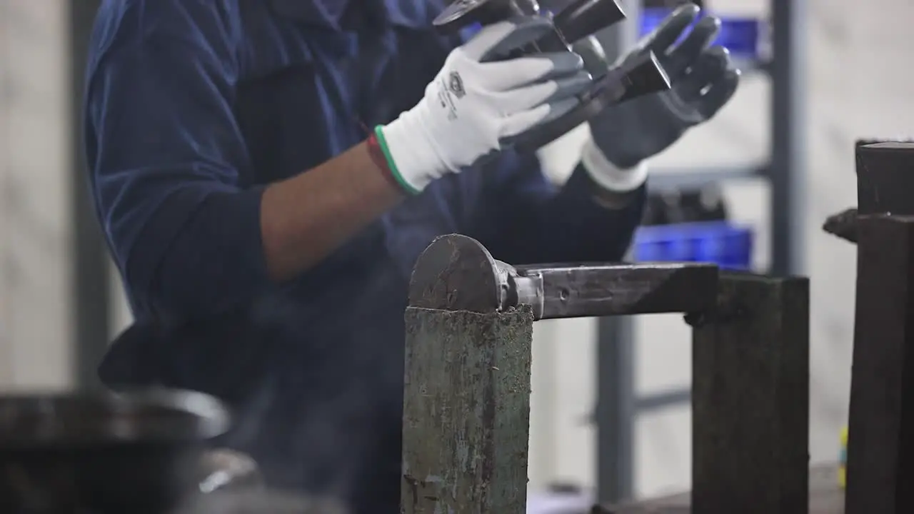 close-up scene in which an employee is gluing wax molds together with components