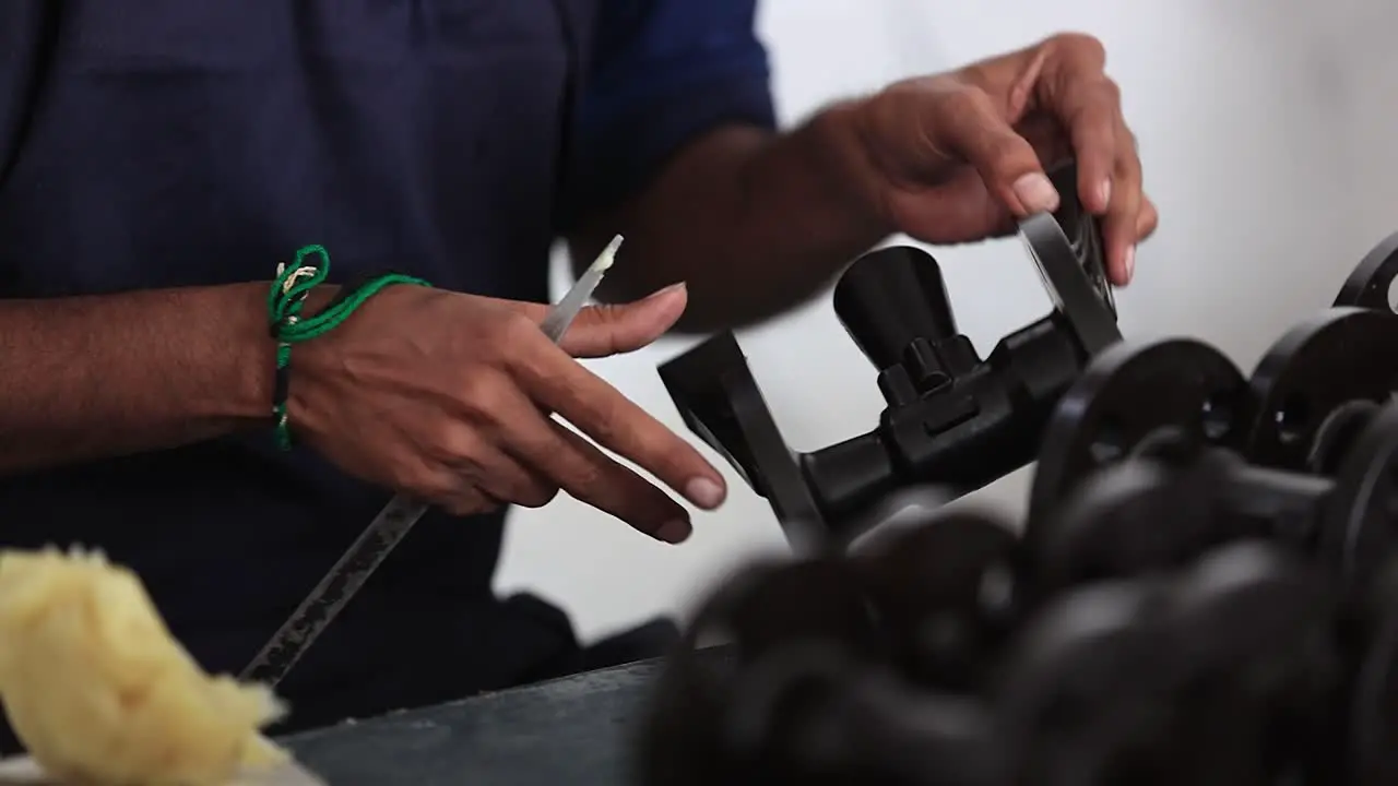 close-up scene in which an employee is checking the quality of a mole of wax prepared