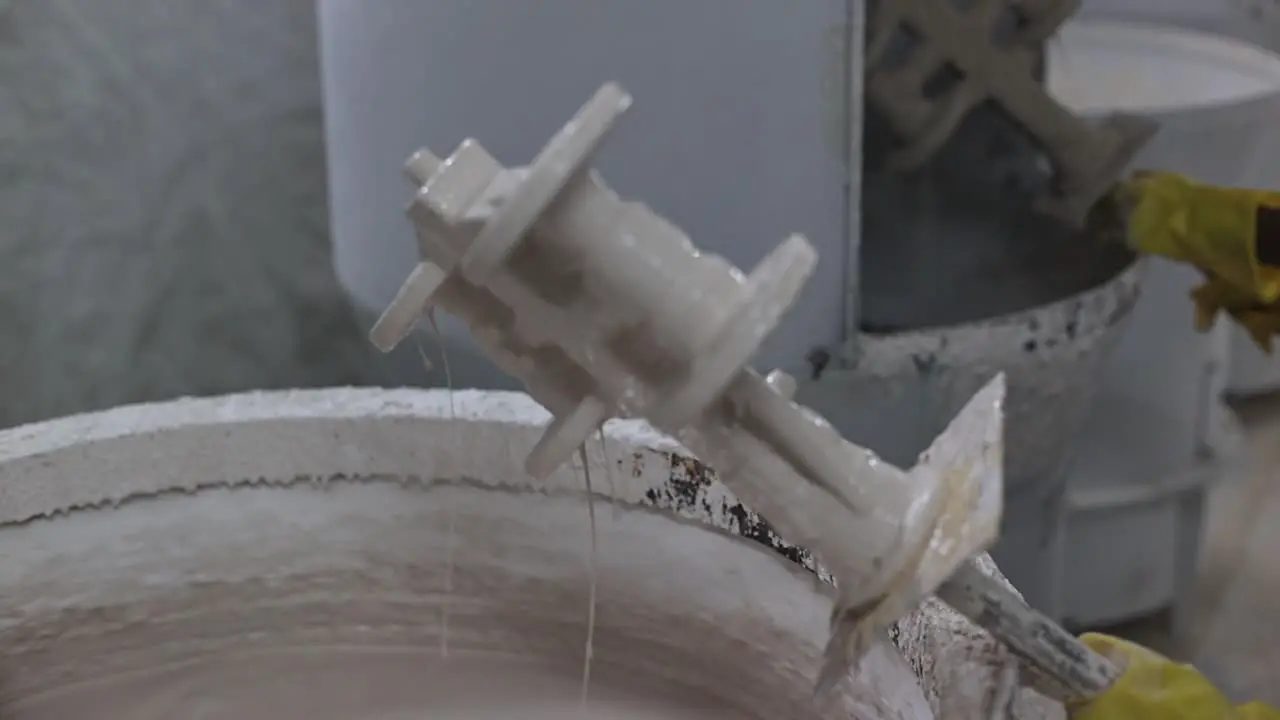 A mold prepared by wax is being soaked in sand