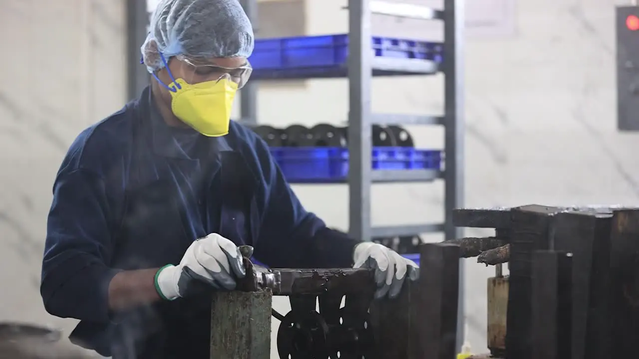 wide scene in which an employee is working on gluing wax molds in industries