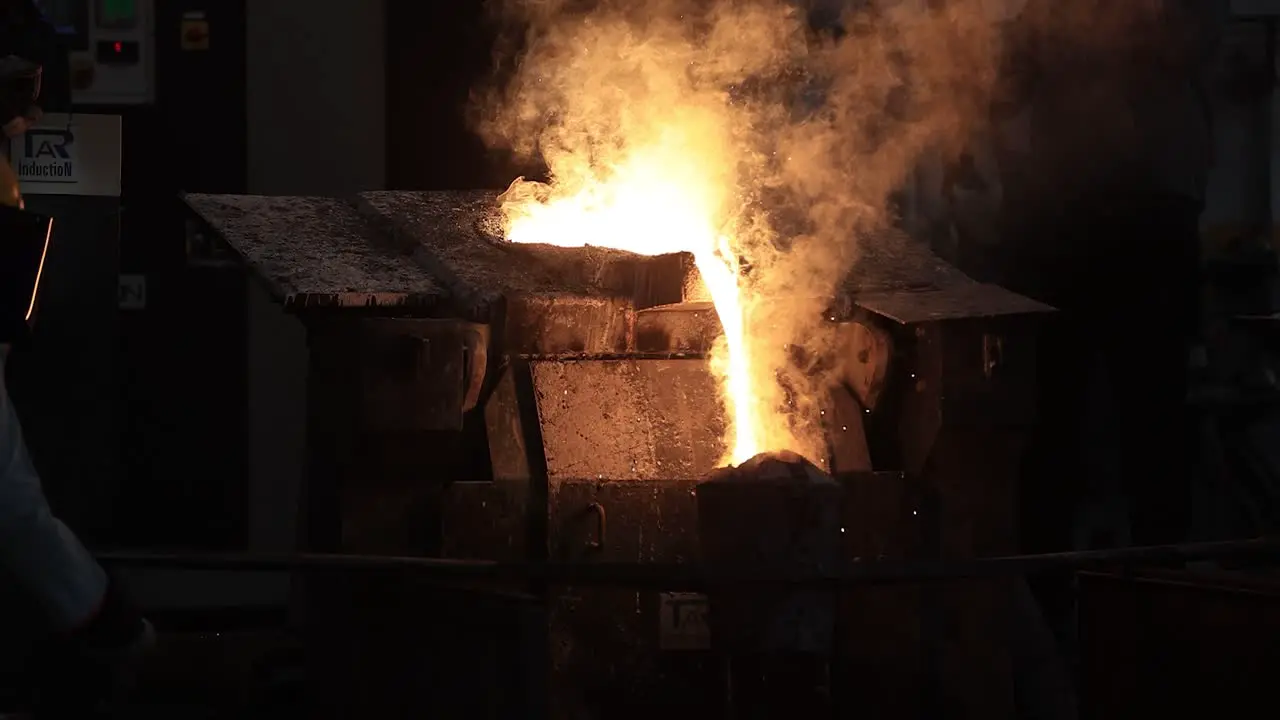 close up seen iron is taken out of the furnace and prepared for the moulds