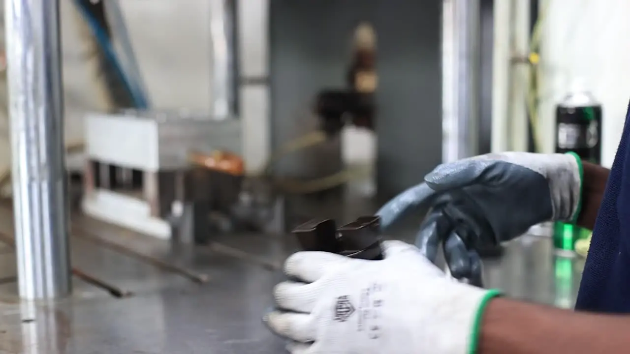 close up scene of the operator separating the wax mold from the die