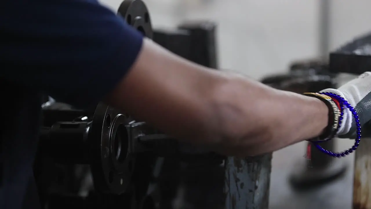 Front view of an employee gluing a wax mold with heated wax