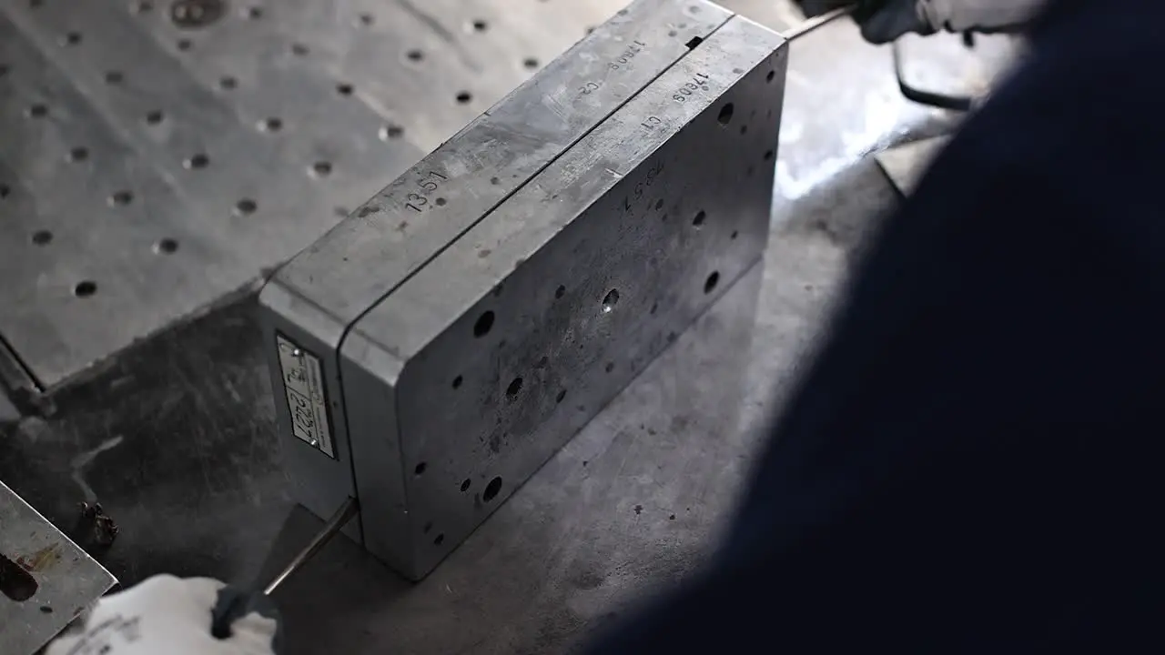 Front view of a machine operator opening the die of an investment casting mold