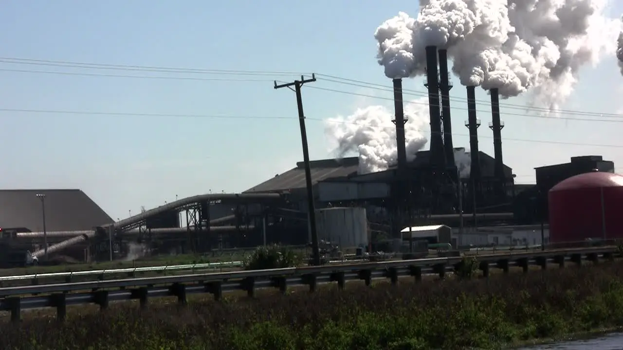 A power plant with smokestacks belches smoke into the air 3