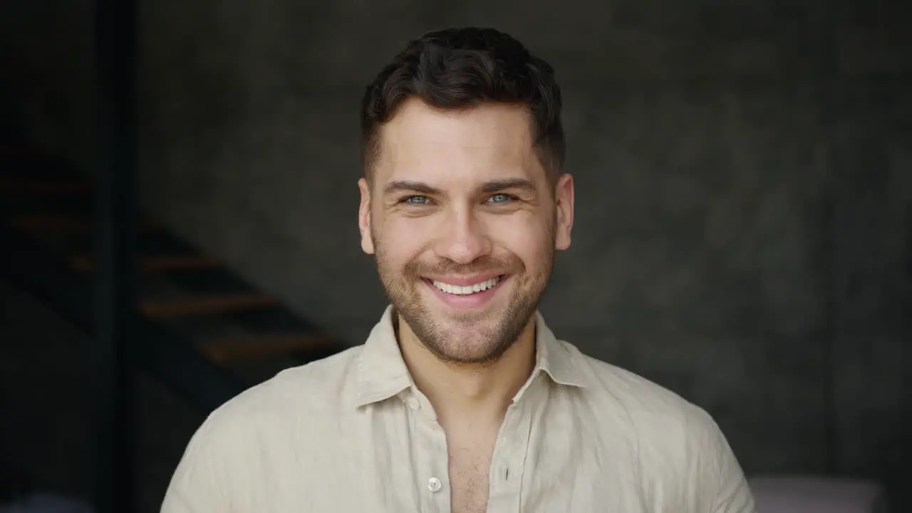 Young Man Smiling And Laughing Looking At Camera Indoors