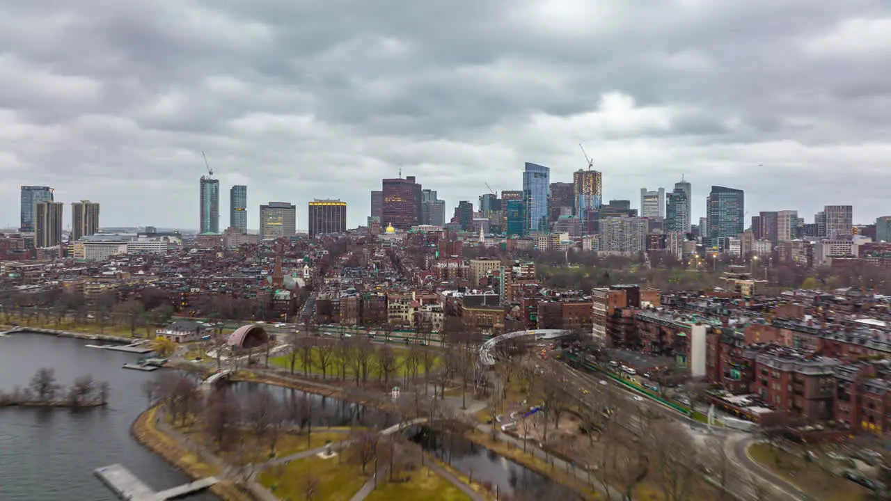 Forwards fly above residential urban borough Hyper lapse short of dusk in large city Modern office buildings in background Boston USA