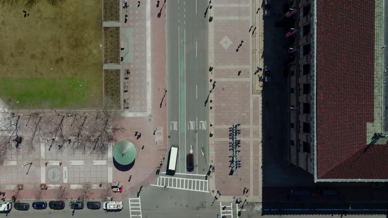 Bird's eye shot of traffic on streets in town Vehicles moving on road and pedestrians walking on pavements and crosswalks Boston USA