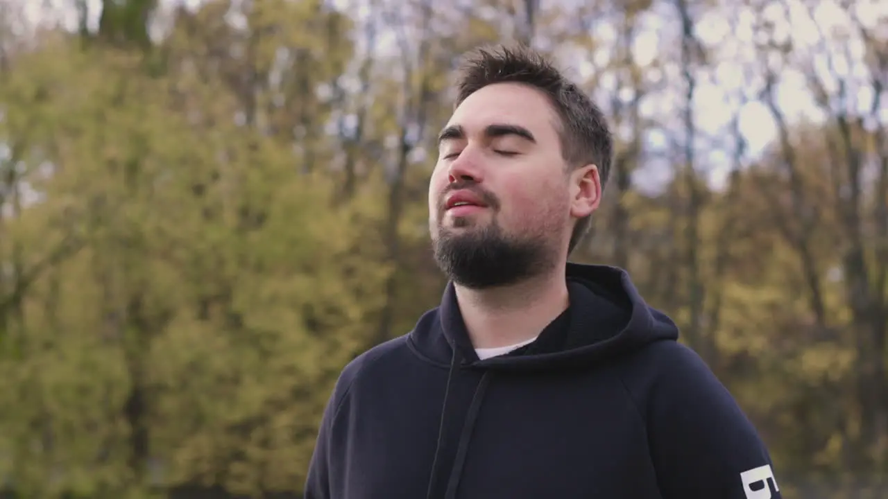 Relaxed Bearded Man Breathing Fresh Air Standing In The Park In The Morning