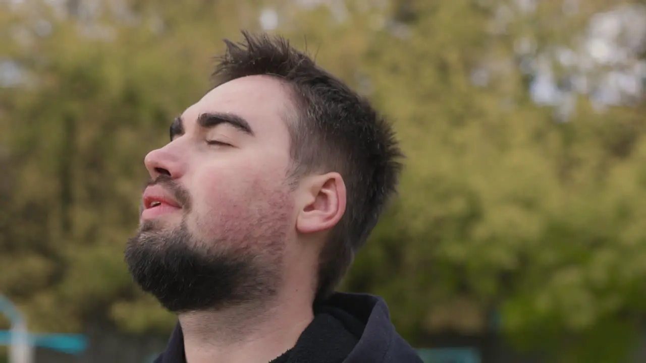 Relaxed Man Breathing Fresh Air Standing In The Park In The Morning