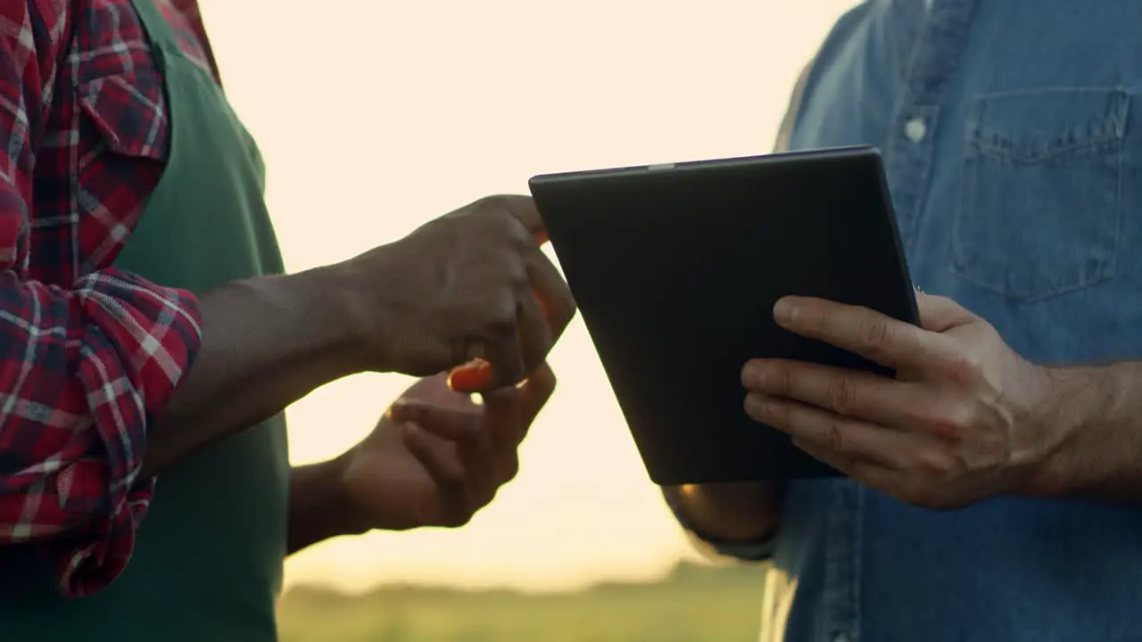 Close Up Of The Male Hands Of The Mixed Races Men Farmers With Tablet Device While They Standing In The Field And Deciding Something Then Shaking Hands