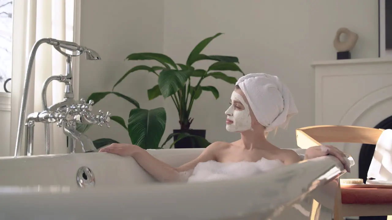 Female With Face Mask Taking A Relaxing Bath