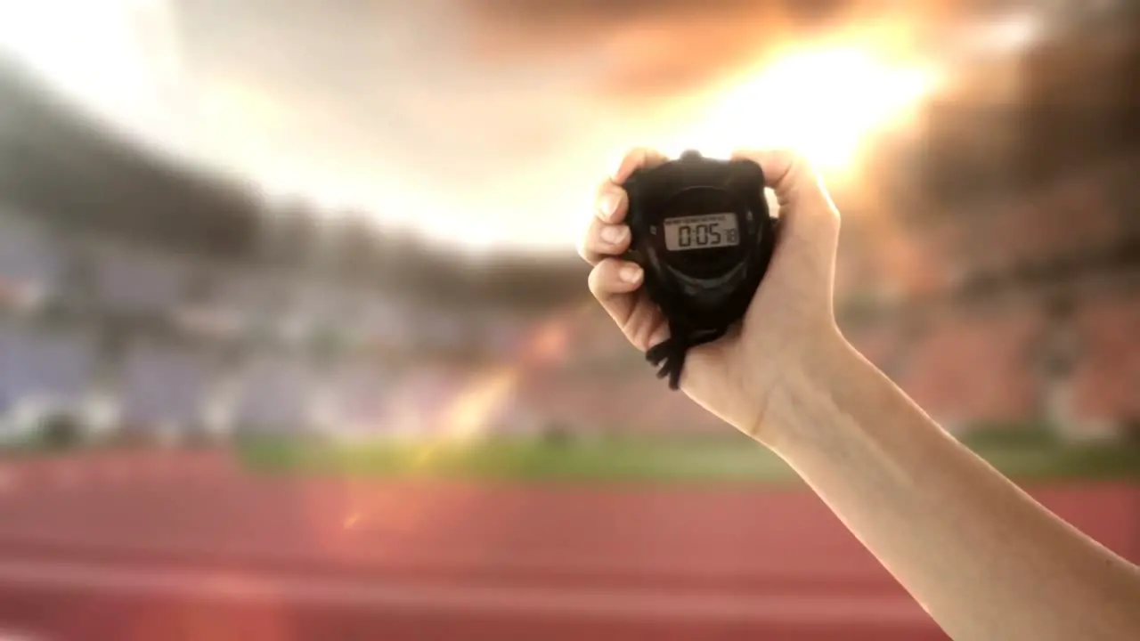 Hand holding stopwatch in olympic stadium