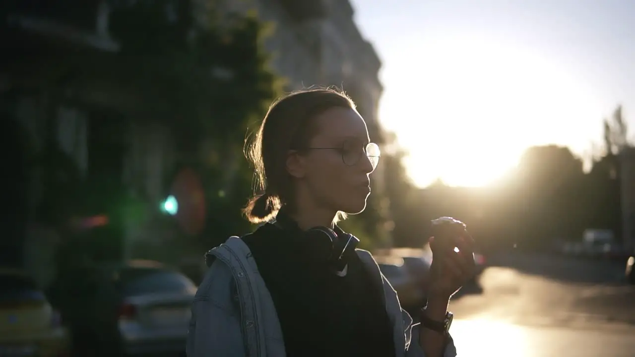 A Girl In Stylish Glasses Eats Ice Cream In A Waffle Cone In The Rays Of Sunset