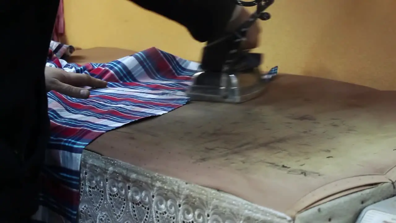 Tailor Ironing After Sewing