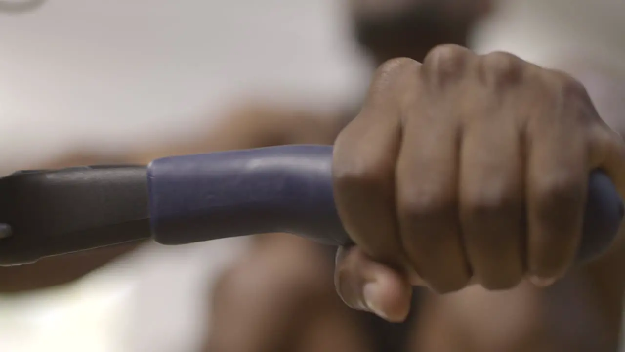 Mans Hands Whilst Rowing in Gym