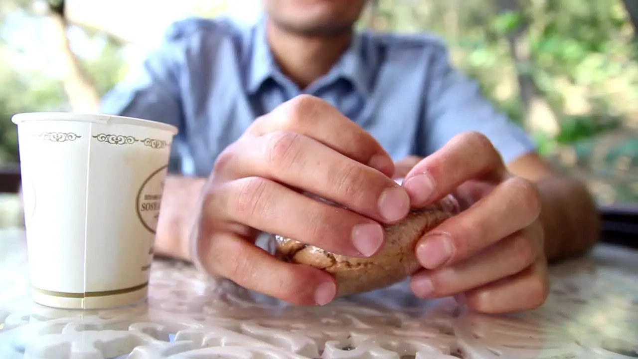 Young Man Eating Cake In Cafe