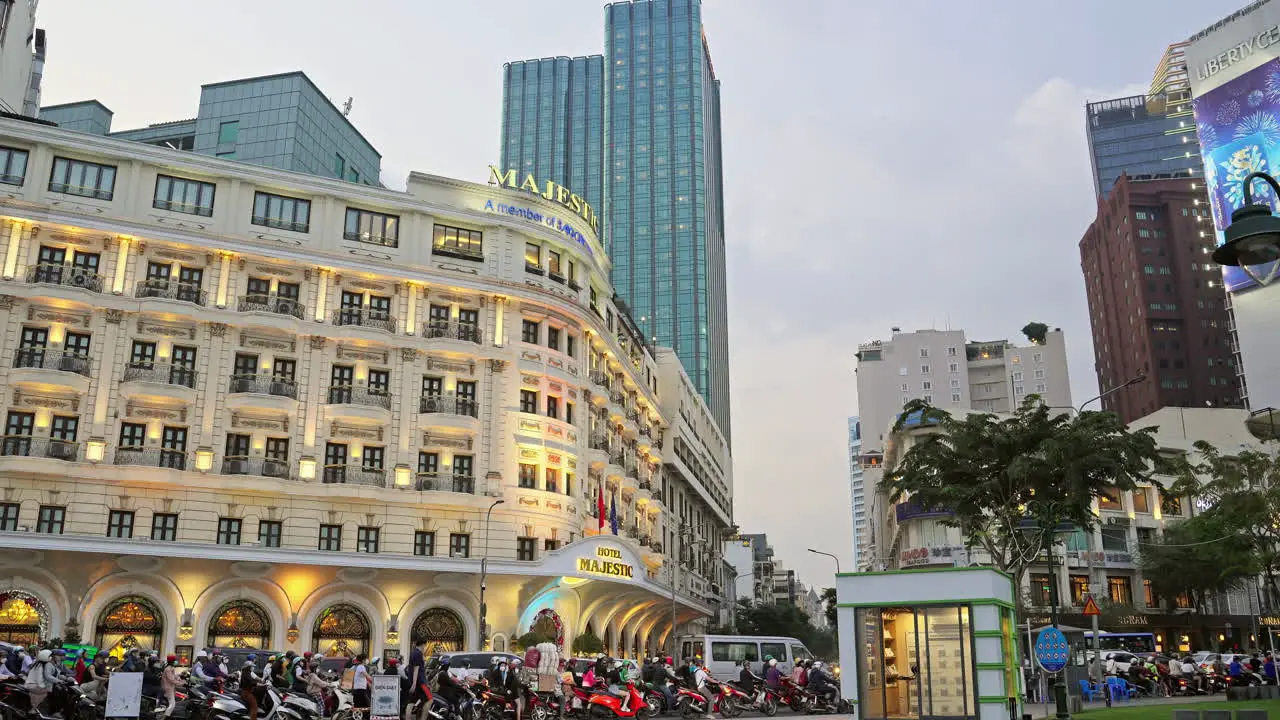 Capture the vibrant traffic scene in front of the iconic Majestic Hotel in Saigon Vietnam