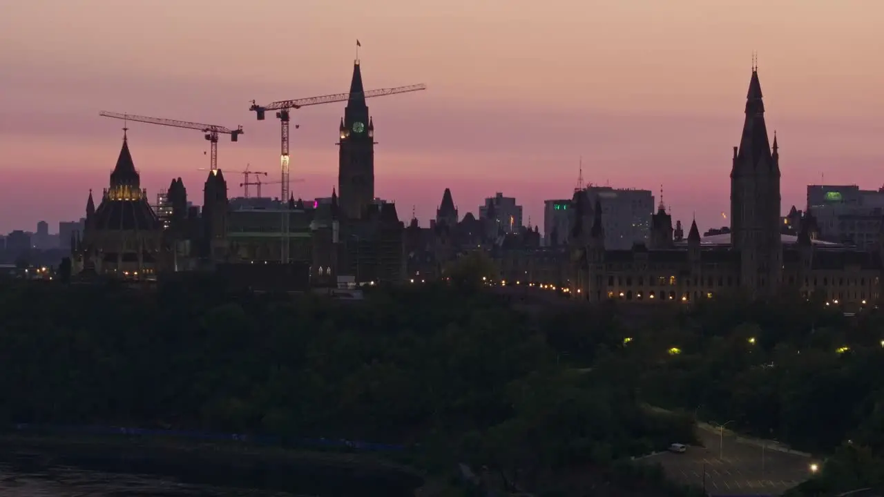 Telephoto drone video of the Canadian parliament buildings in Ottawa Ontario Canada at sunrise the buildings are silhouetted against the sky