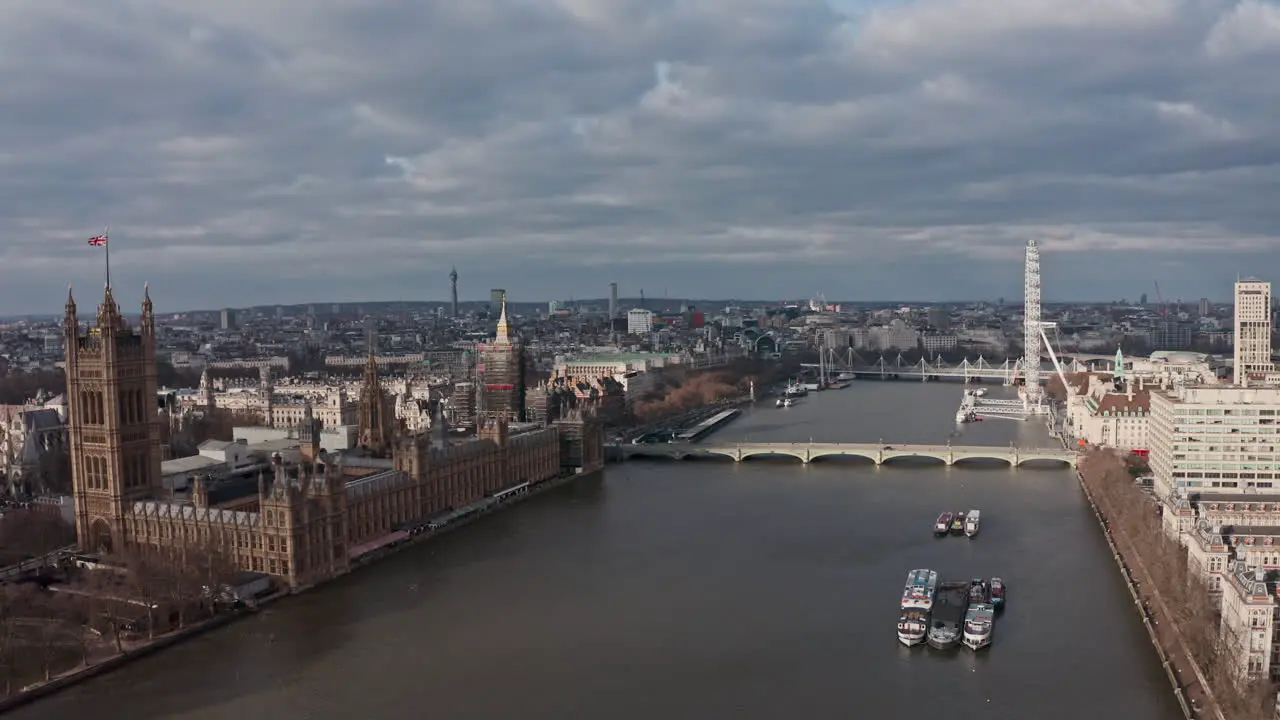 Aerial drone shot towards London houses of parliament palace of Westminster London eye