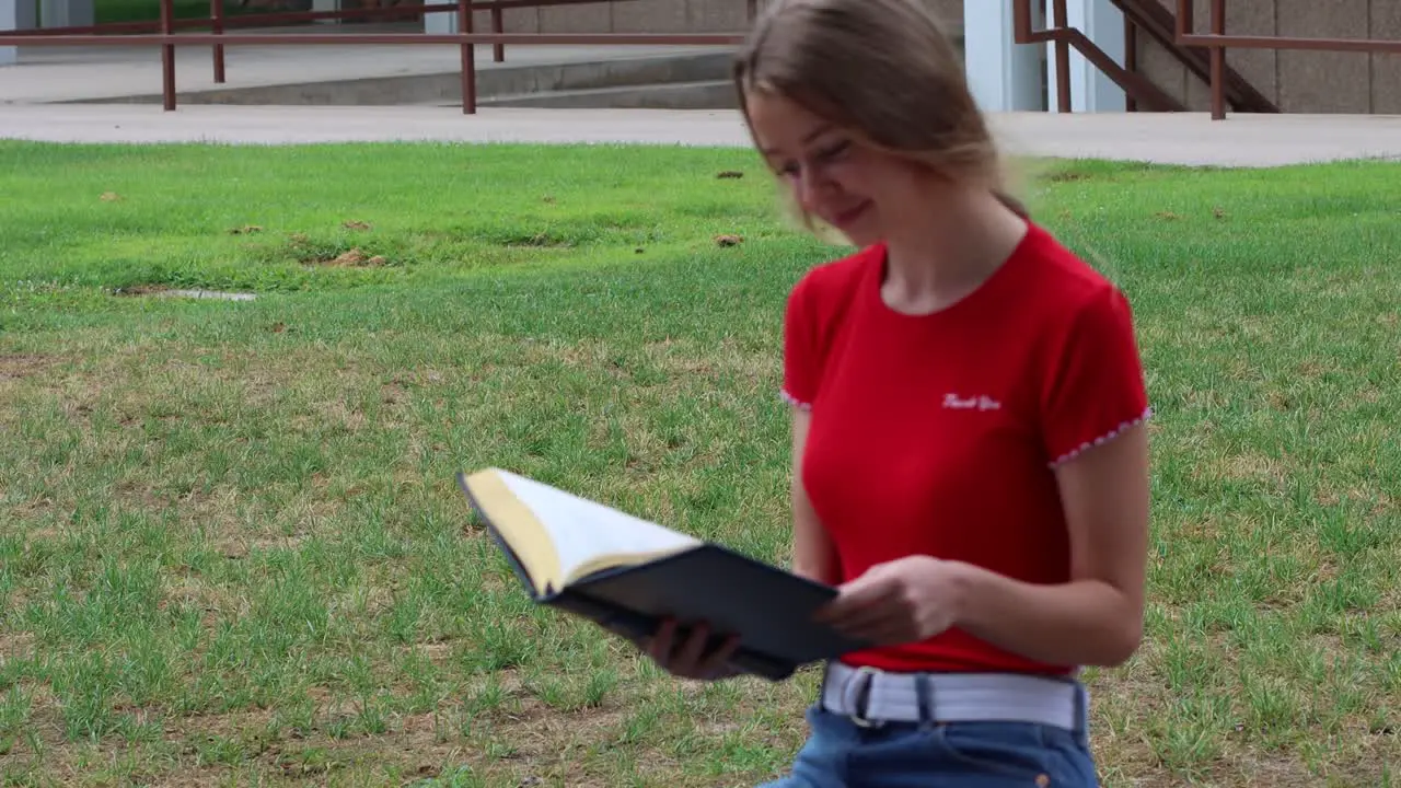 Reading in the campus commons a young woman studies the classics