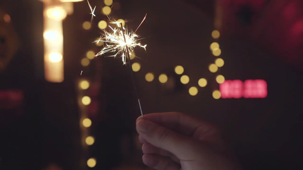 Holding a bright sparkler burning down