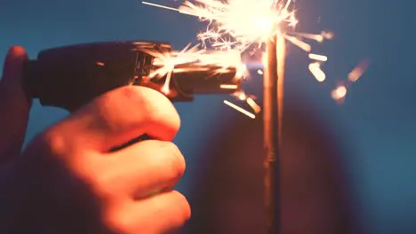 Hand of person lighting a sparkler