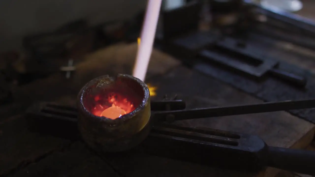 Close up of flame from gas burner melting metal for jewelry