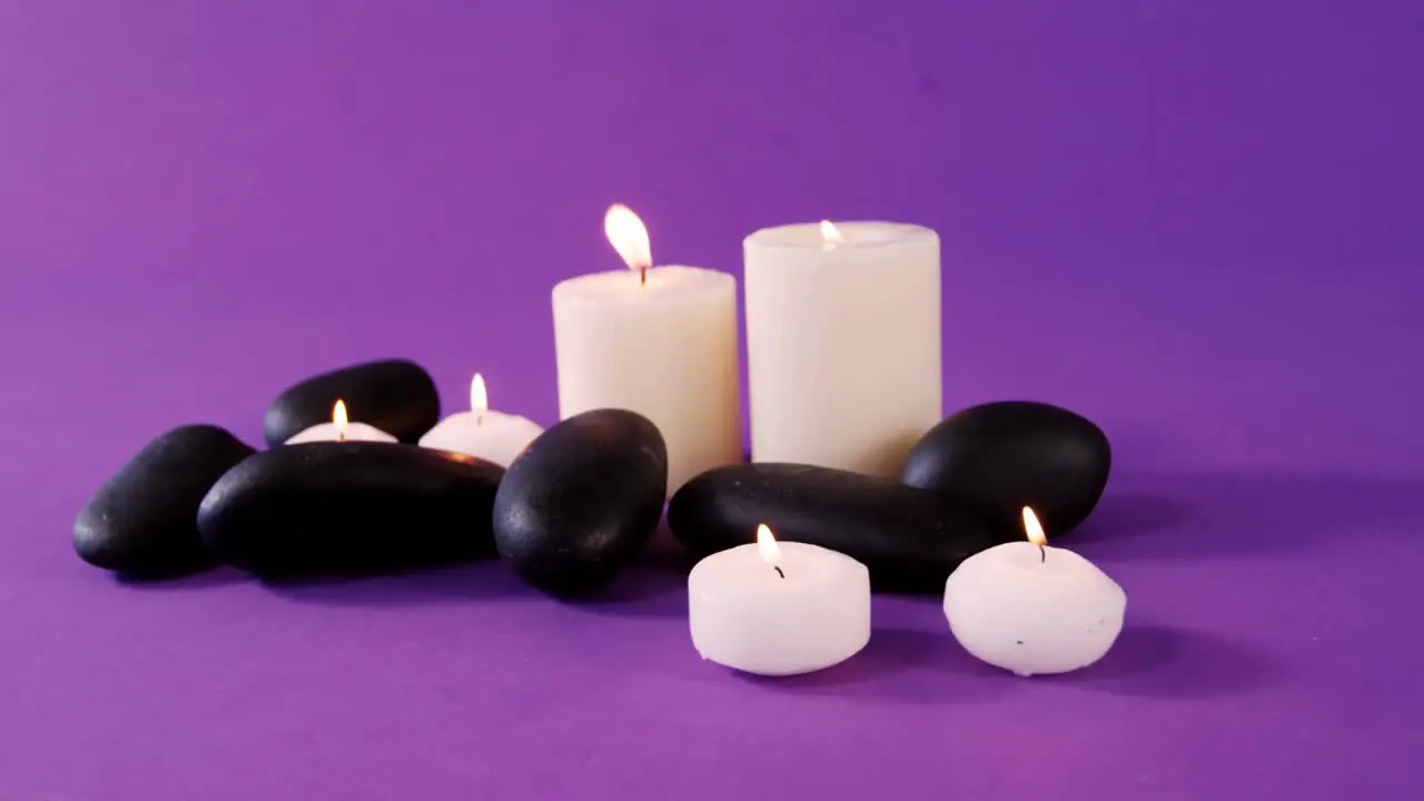 Pebbles and candle on table