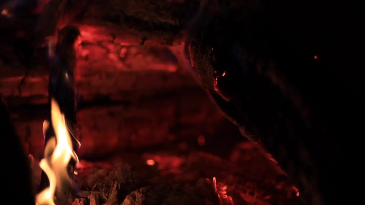 Tight shot of logs burning in a fire pit