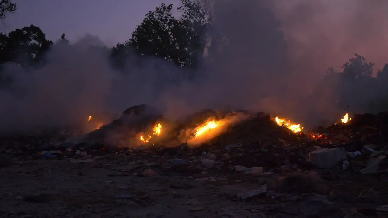 The sun sets in India as rubbish burns in a rubbish dump on an island in the Andaman Sea