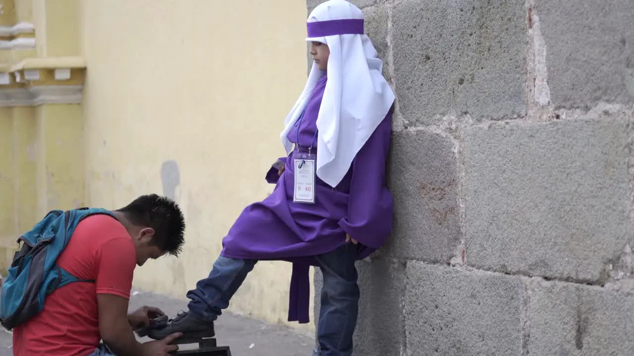 Young cucharucho gets a shoe shine Holy Week in Antigua Guatemala