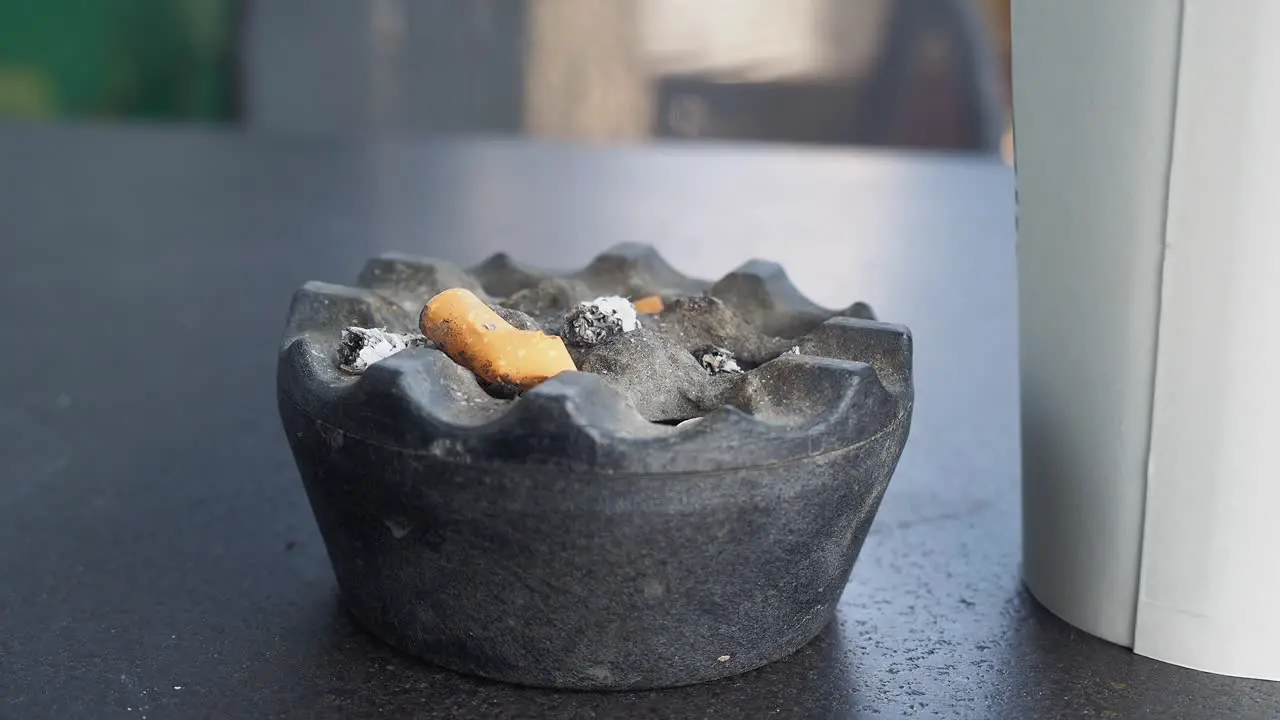 Close up burning cigarette in ashtray 