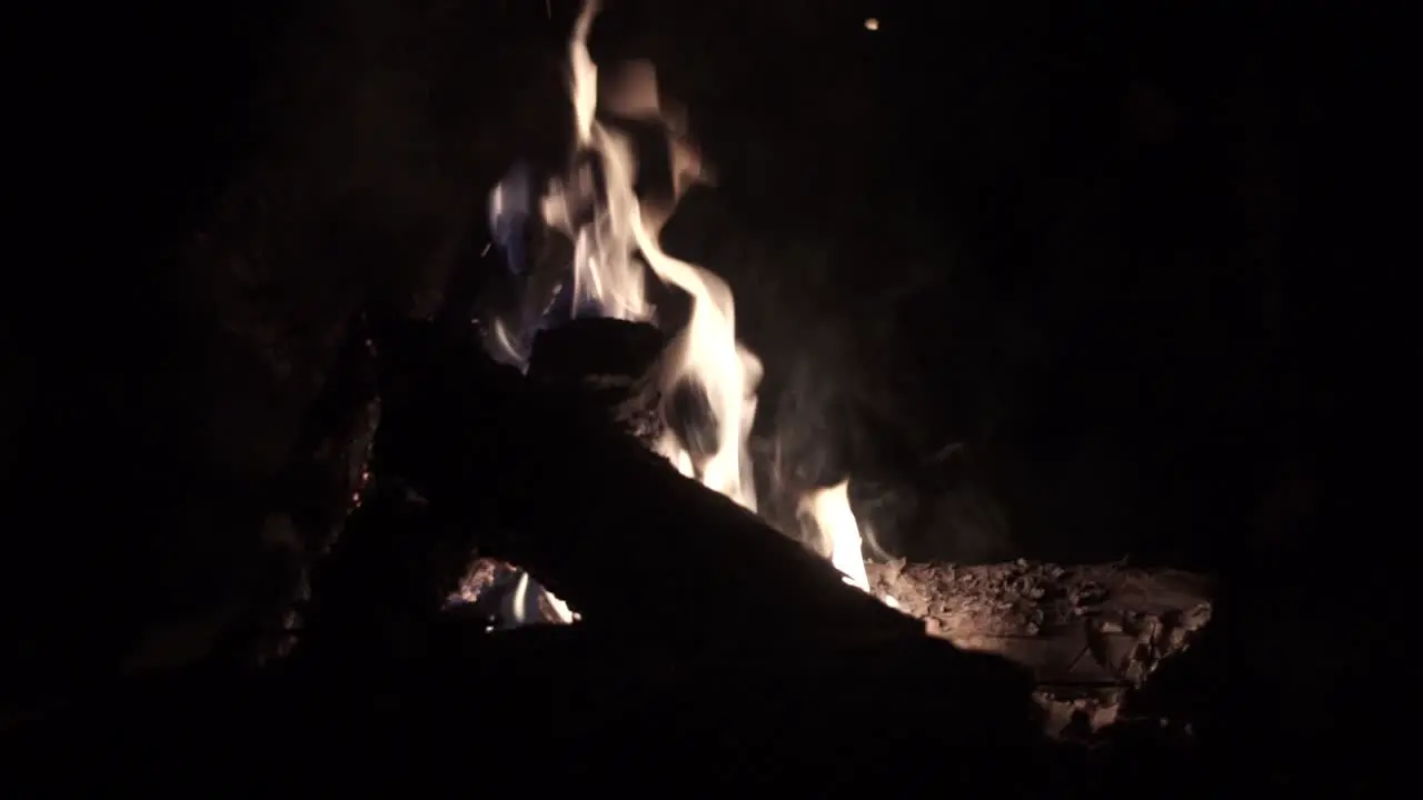 Warm static camp fire shot with flames embers and smoke