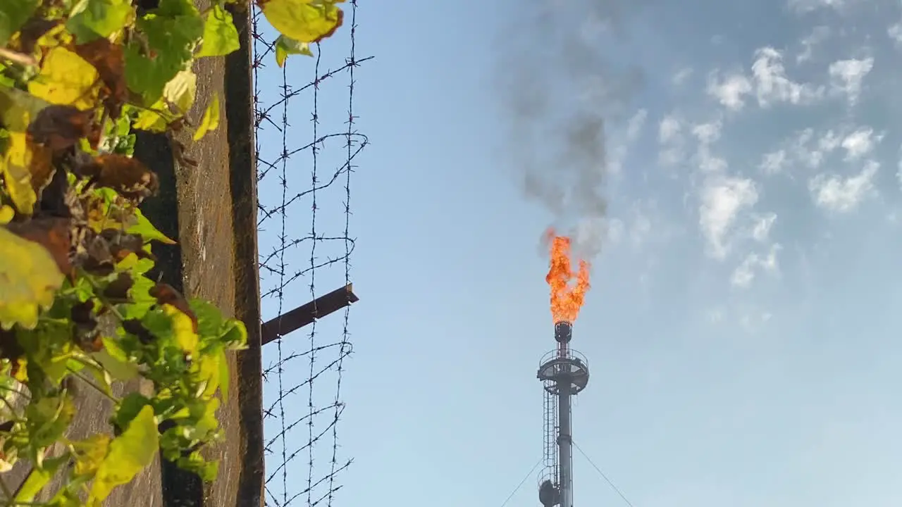 Gas Plant Pipe Burning by Barbed Wire Fence