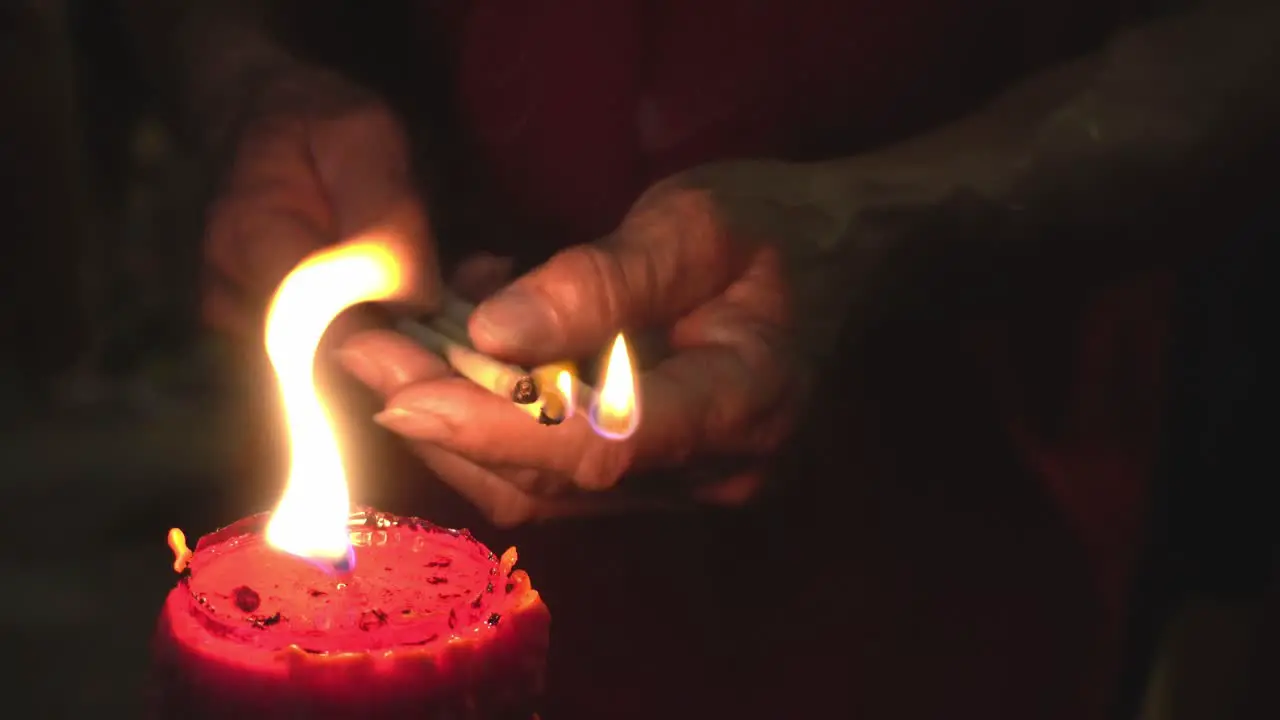 Close up hand devotee hold joss stick