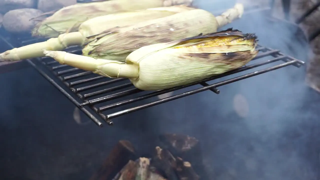 Making corn on the cob over an open fire flame