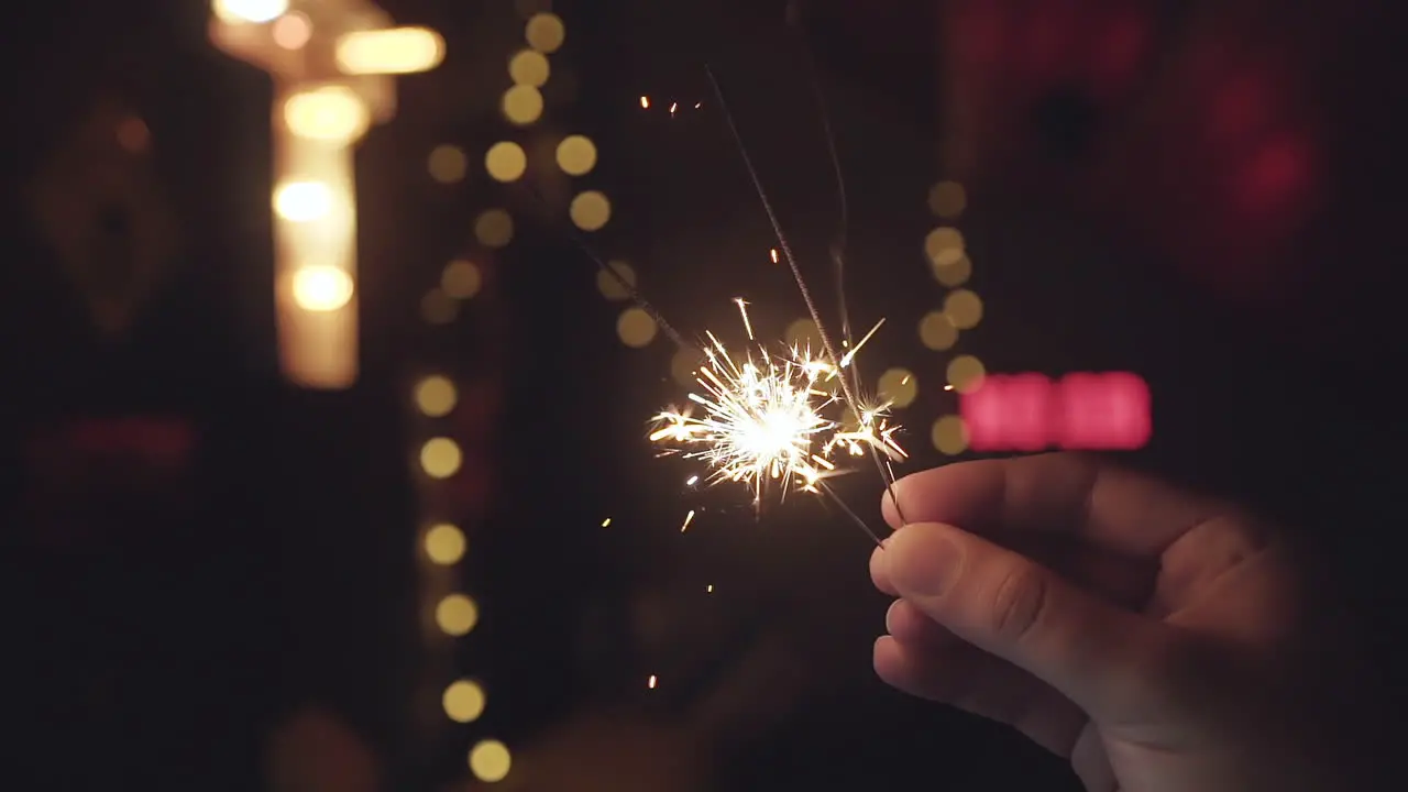 Bright sparklers burning down in slow motion